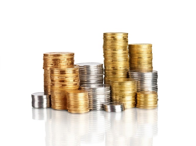 Neatly stacked rows of gold and silver bullion side by side.